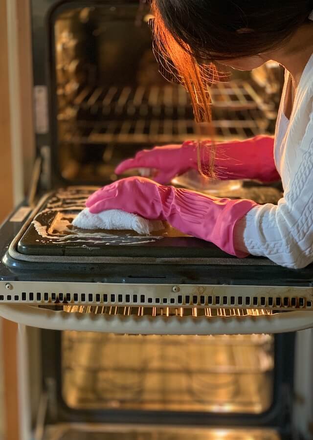 Woman Cleaning a Double Oven