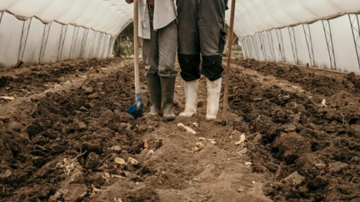 Focus on legs wearing working boots and working tools