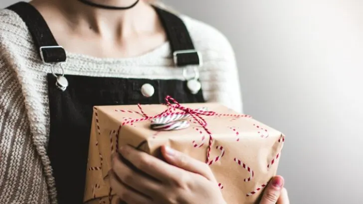 Woman holding a box of gift wrapped with an eco-friendly gift wrapper