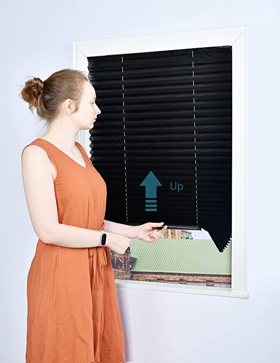 woman pulling up black blinds