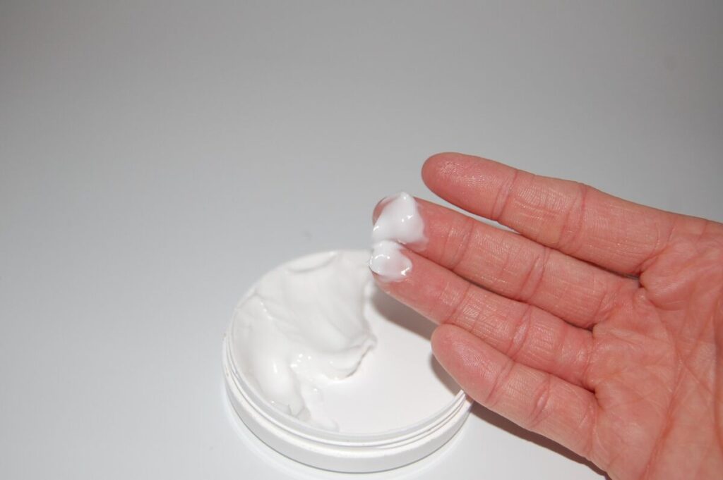 Hand with a cosmetic cream