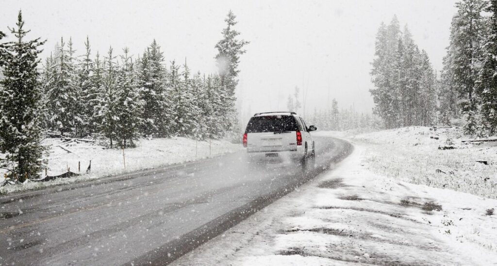 Car passing a road without a snow 