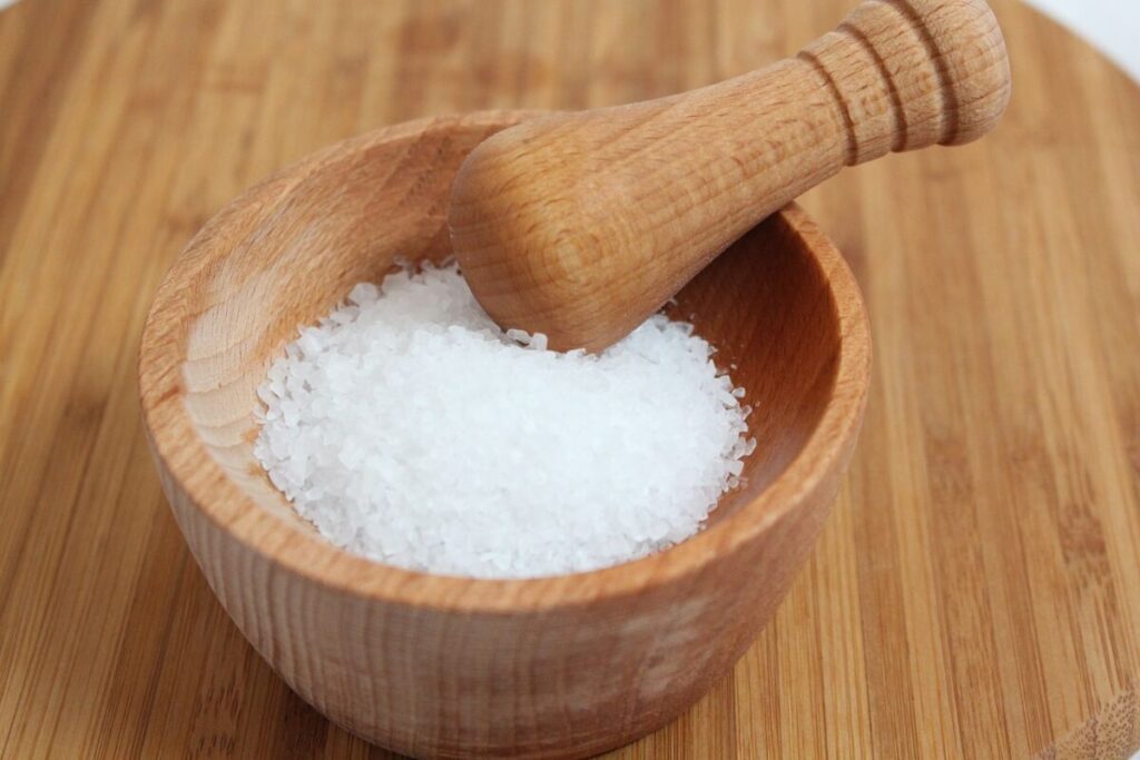 Rock salt on a wooden mortar and pestle